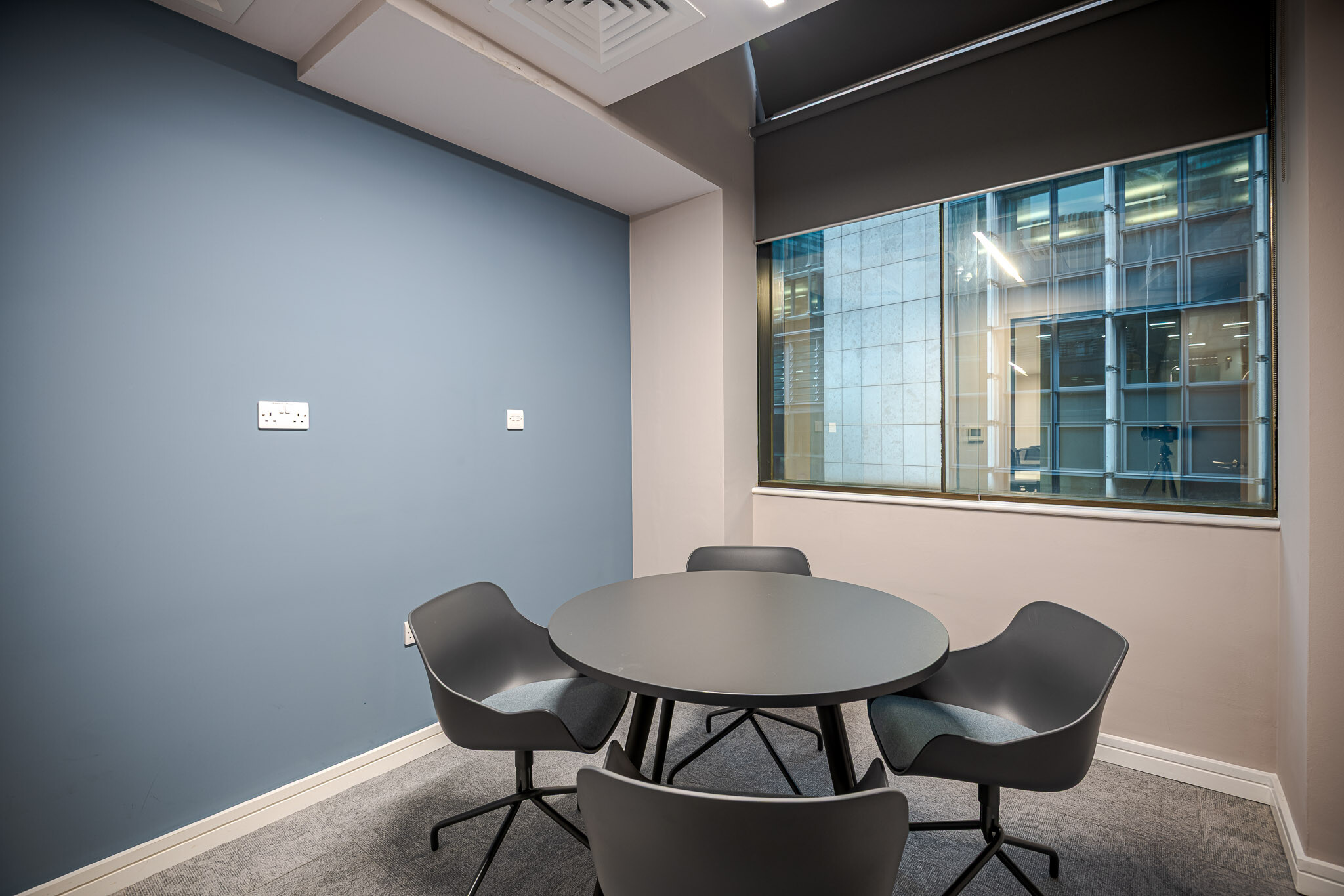 Alchemy Asset blue meeting room with an open view of the city