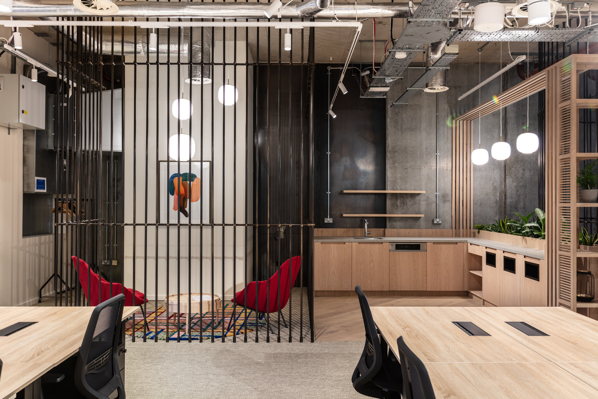 Collaborative workspace at FORA Borough Market, designed by Two, featuring open shelving, pendant lighting, and modern office furniture.
