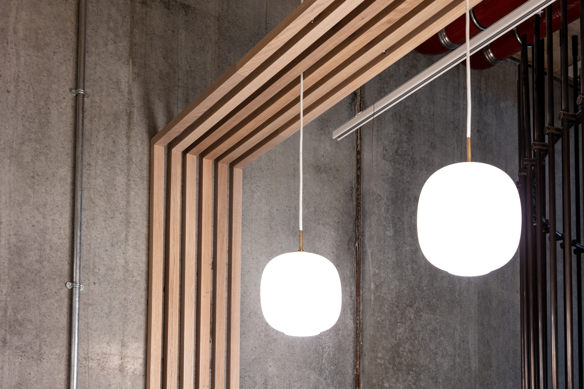 Close-up of pendant lighting and wooden panel details in the FORA Borough Market coworking space, designed by Two