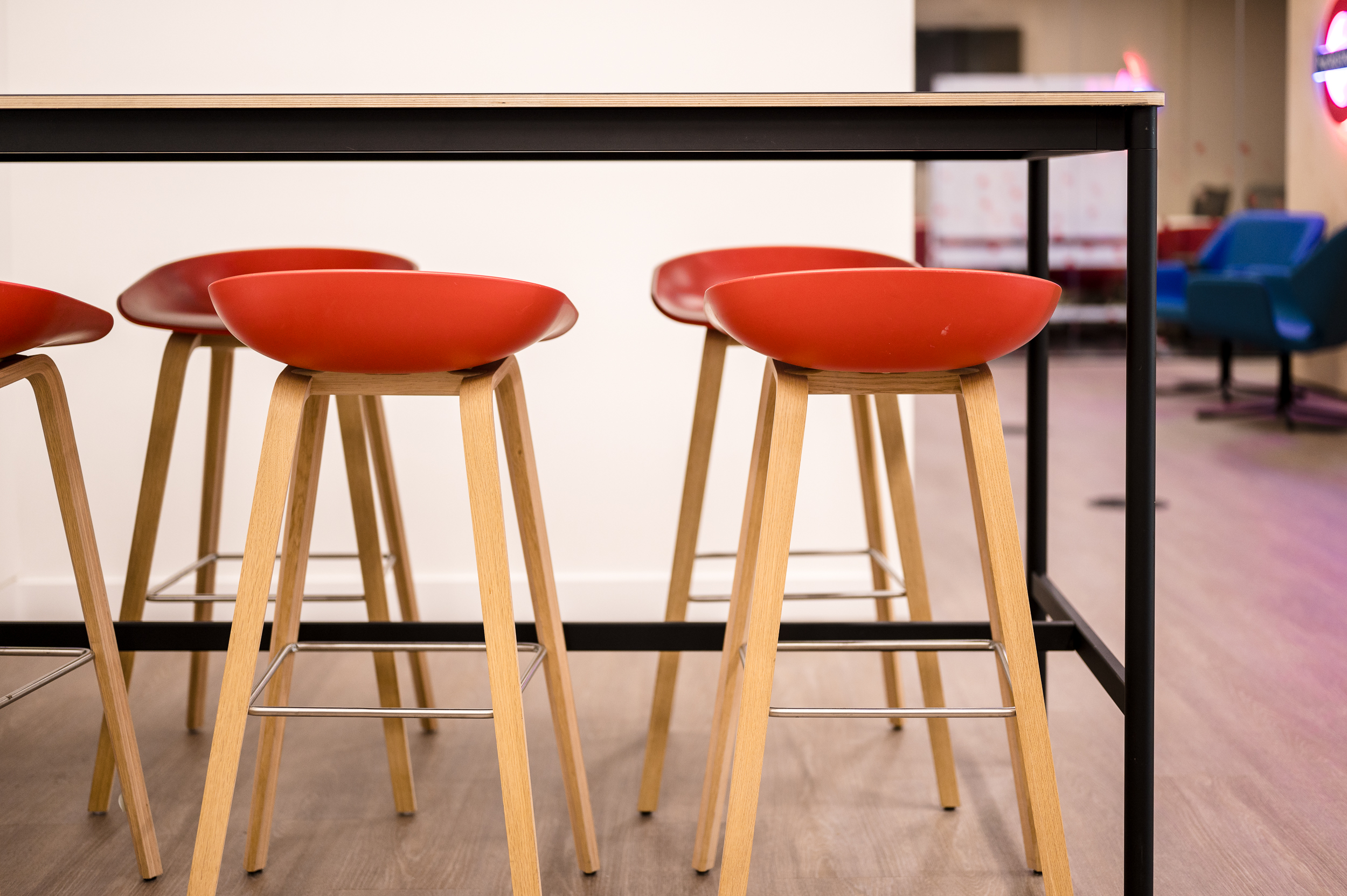 Close-up of red stools in the teapoint at MicroStrategy’s office, part of the vibrant and practical workspace designed by Two.