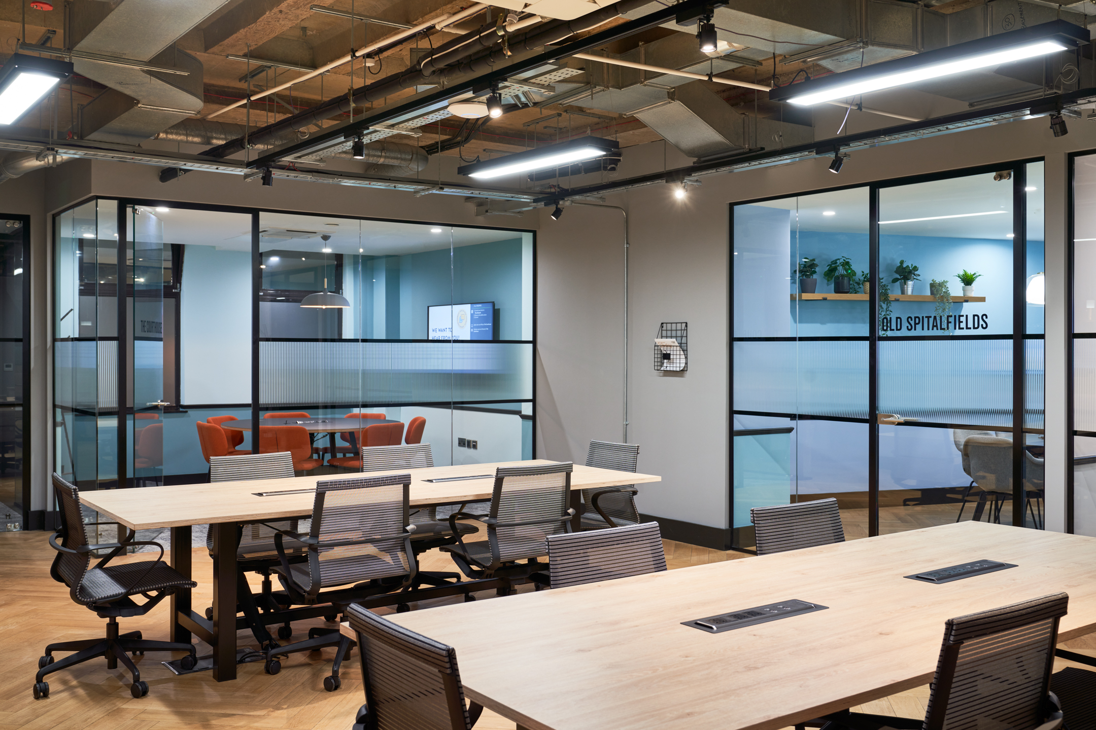 A dynamic open-plan workspace at Work.life Liverpool Street, with sleek wooden desks, ergonomic chairs, and private meeting rooms designed by Two for a professional and flexible work environment.