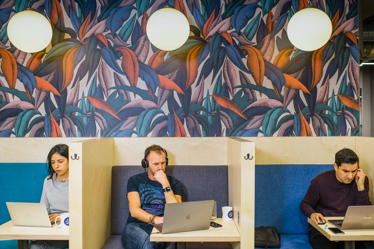 Dedicated work pods at Work.life Soho, designed by Two, with colourful wall art, individual seating, and an inspiring workspace layout.